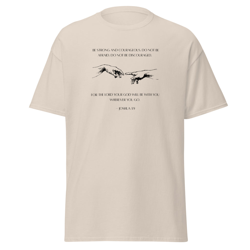 Natural beige T-shirt with black reaching hands and the Be Strong and Courageous Bible verse from Joshua 1:9, front view.