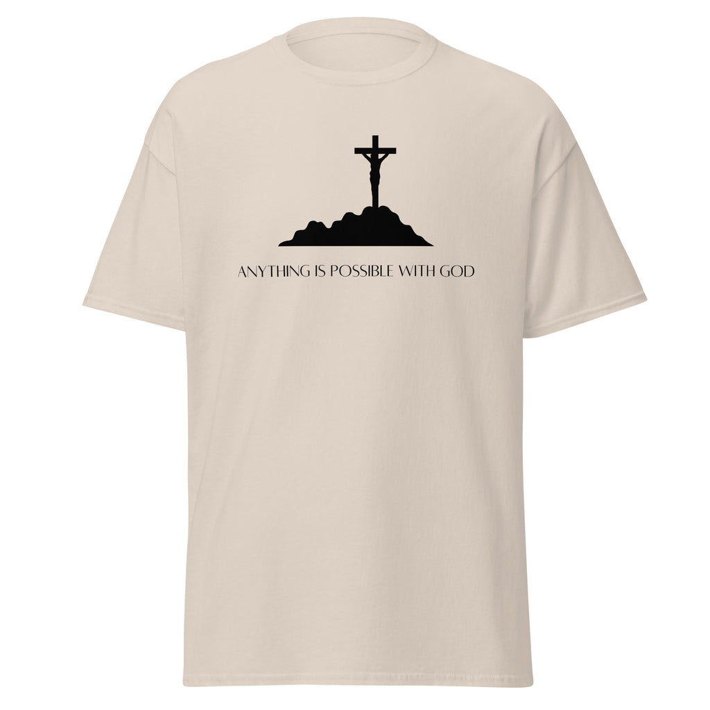 Natural beige T-shirt with a black crucifix on a hill above Anything Is Possible With God lettering, front view.